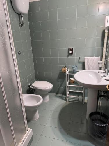 a bathroom with two toilets and a sink and a shower at Park Hotel Villamaria in Pavona
