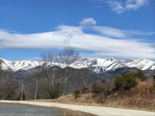 a view of snow covered mountains from a road at Villa La Liberté in Arles-sur-Tech