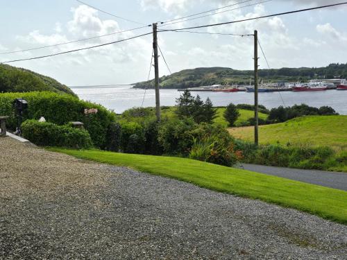 a gravel road with a view of a body of water at Benroe House - 5 bedrooms in Killybegs