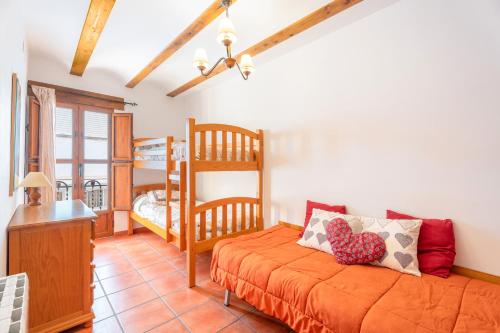 a bedroom with a bed and a bunk bed at Cueva De La Portería in Chulilla