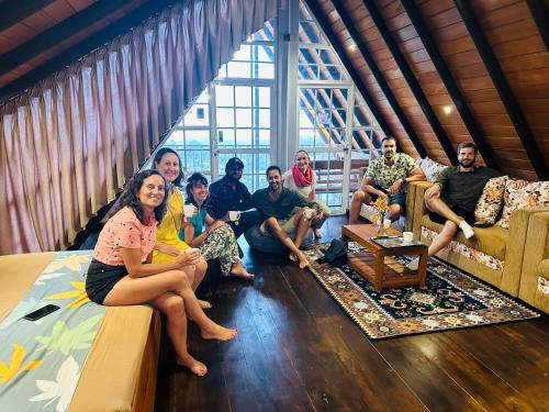 a group of people sitting in a living room at Cabin 7000 feet Nuwaraeliya in Nuwara Eliya