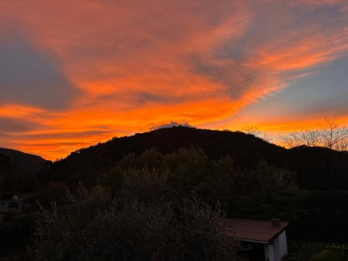 a sunset with a mountain in the background at Villa La Liberté in Arles-sur-Tech