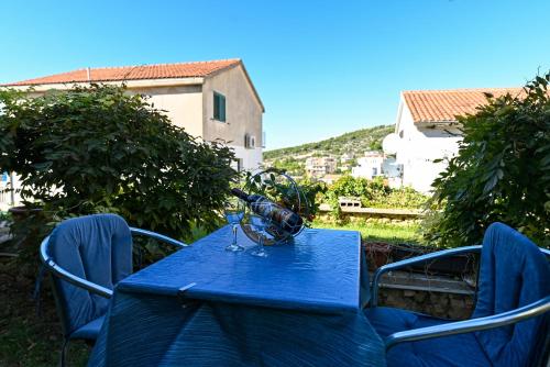a blue table with a wine glass on it at Apartments Marić in Primošten