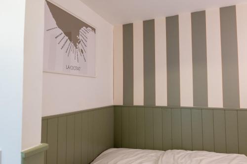 - une chambre avec des murs rayés et un lit dans l'établissement La Tiny - Sleep in La Ciotat, à La Ciotat