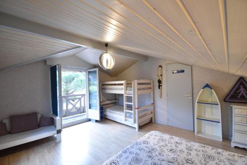 une chambre avec deux lits superposés et un plafond dans l'établissement Hossegor Belle villa avec piscine pour 10 personnes., à Hossegor