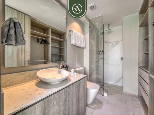 a bathroom with a sink and a toilet and a shower at Luxury 3 BR Condo - Beach Access 1 Block Away in Bucerías