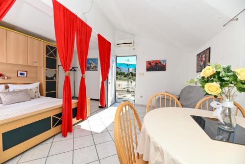 a bedroom with a bed and a table and a couch at Apartments Marić in Primošten