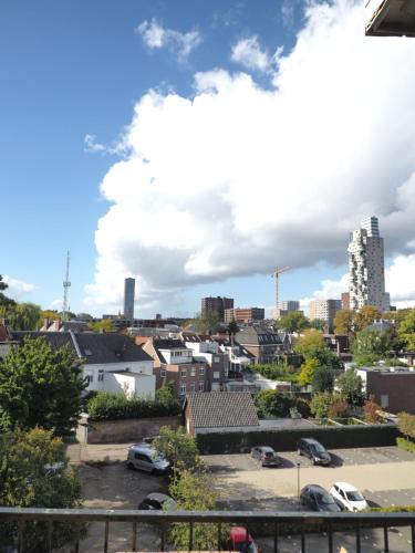 a view of a city with cars parked in a parking lot at Hostel Roots in Tilburg