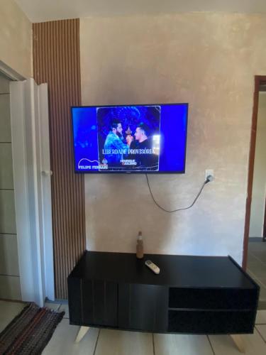 a flat screen tv hanging on a wall at Minas Hotel Uberlândia in Uberlândia