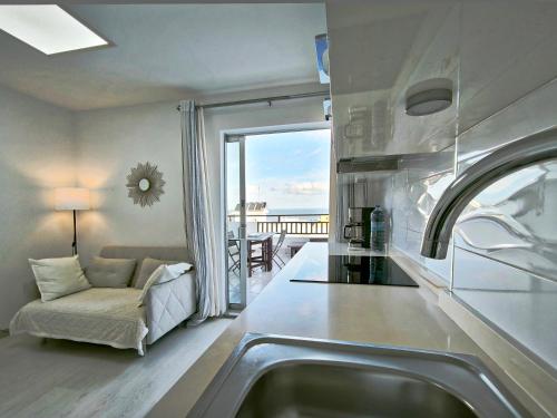 a kitchen with a sink and a view of the ocean at Girasol Rooftop View in Puerto de la Cruz