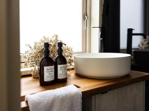 two bottles of wine sitting on a counter in a bathroom at The Forest at Mount Congreve Gardens in Kilmeaden