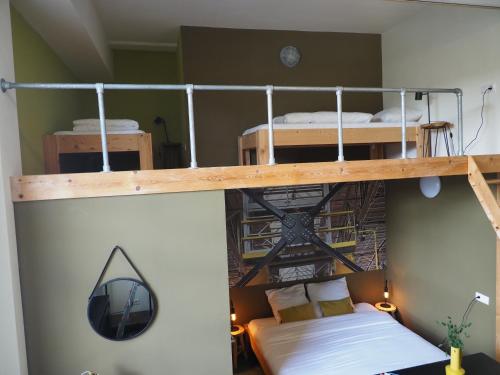 a bedroom with two bunk beds in a room at Hostel Roots in Tilburg