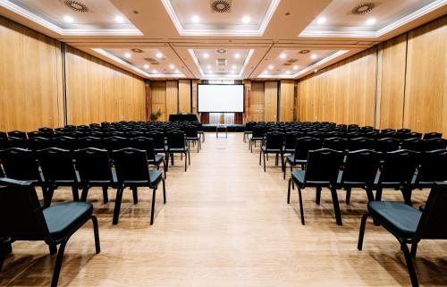 an empty lecture hall with chairs and a screen at Grande Real Santa Eulalia Resort & Hotel Spa in Albufeira
