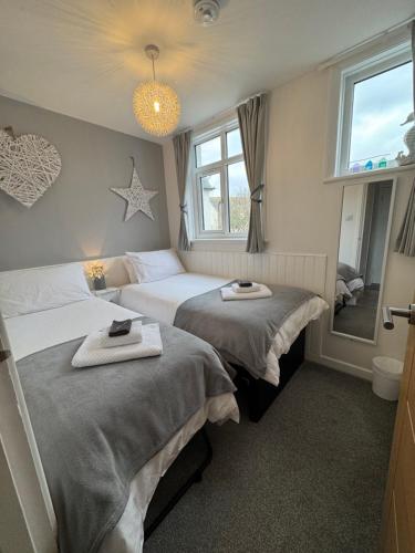 a hotel room with two beds and a window at WORTHING BEACH 180 - 2 bed seafront apartment with private parking in Worthing