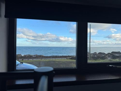a view of the ocean from a window at The Shed Galboly in Glenariff