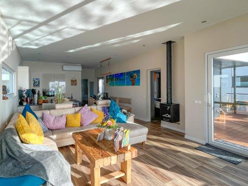 a living room with a couch and a table at Floating Hideaway- Coco de Mer in Ribnitz-Damgarten