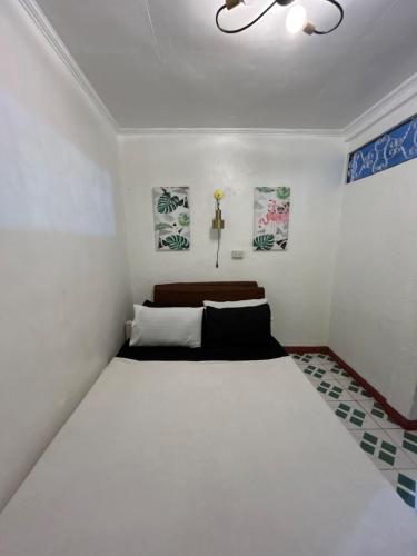 a bedroom with a large white bed in a room at ACL Staycation Home in Imus & Kawit with mini pool Unit 3 in Kawit