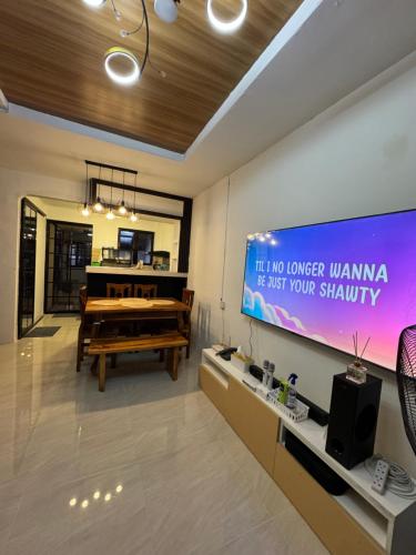 a living room with a television and a piano at Casa Mira in Dasmariñas