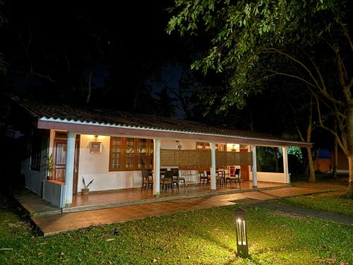 a small house with a deck at night at Hotel 4 U Saliya Garden in Anuradhapura