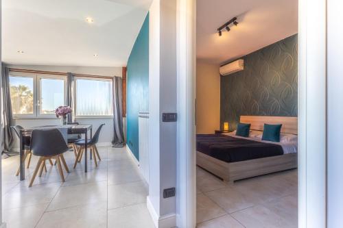 a bedroom with a bed and a table and a dining room at Katrina's Home alloggio turistico in Fiumicino