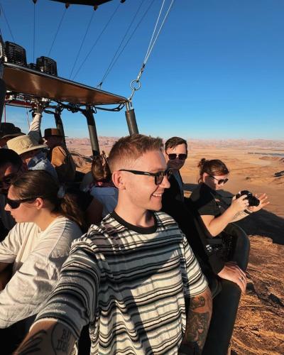 a group of people riding in a gondola in the desert at Charlotte luxury camp in Wadi Rum