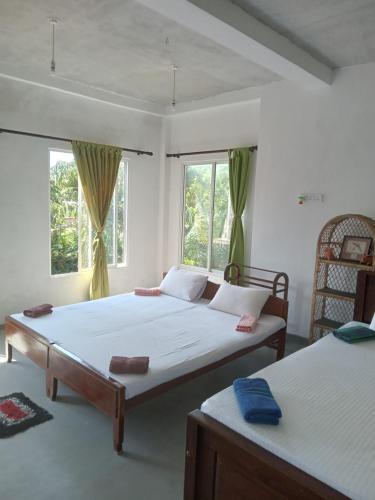 Ένα ή περισσότερα κρεβάτια σε δωμάτιο στο Mallika Resort