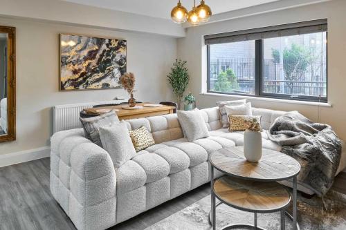 a living room with a couch and a table at Host & Stay - Chic Townhouse by the Docks in Liverpool