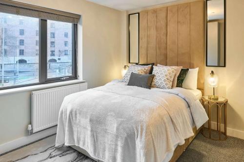 a bedroom with a large bed and a window at Host & Stay - Chic Townhouse by the Docks in Liverpool
