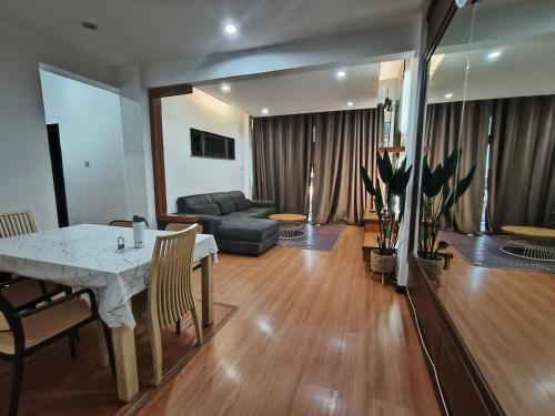 a living room with a table and a couch at Kuhara Homestay in Tawau