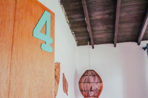 a sign on a wall with a pendant light at Casa Profunda - Santa Elena in Medellín
