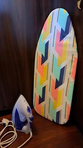 a surfboard and a helmet sitting on a table at Resort Suites at Pyramid Tower by GL Staycation in Petaling Jaya