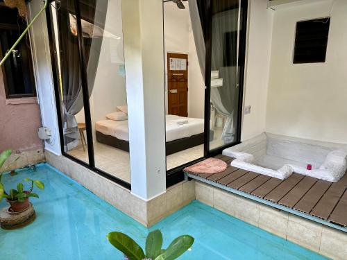 a bathroom with a shower and a blue pool at Ardour Lodge "B" Wing in George Town