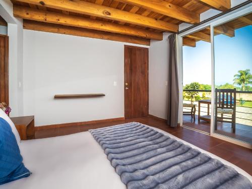 a bedroom with a king sized bed with a view at Hotel Campestre, Valle de Bravo in Valle de Bravo