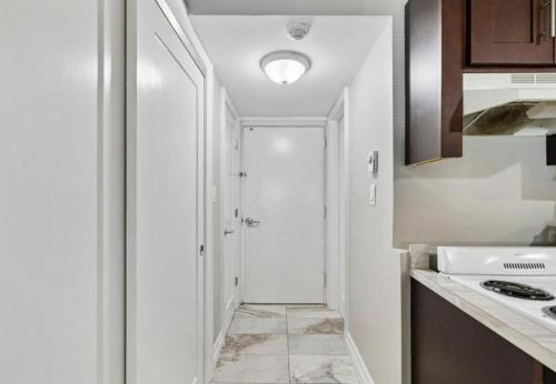 a kitchen with a hallway leading to a door at Upscale Studio in NY with Kitchen & Serene Setting in Congers