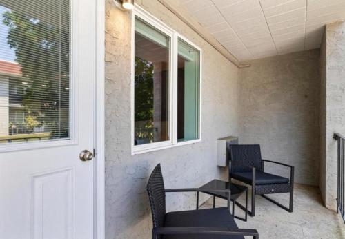 a porch with chairs and a table and a door at Upscale Studio in NY with Kitchen & Serene Setting in Congers