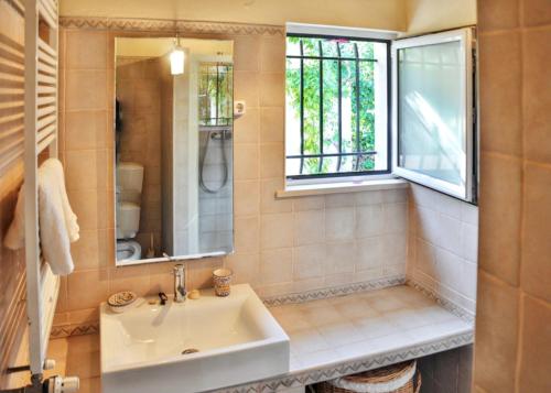 a bathroom with a sink and a window at Elegant Villa in Vilamoura with Private Pool in Vilamoura