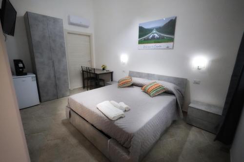 a bedroom with a bed with towels on it at B&B REVOLUTION BED e BREAKFAST in Caserta
