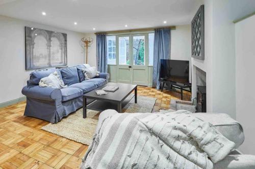 a living room with a blue couch and a fireplace at Host & Stay - St Mary's Riverside in Whitby