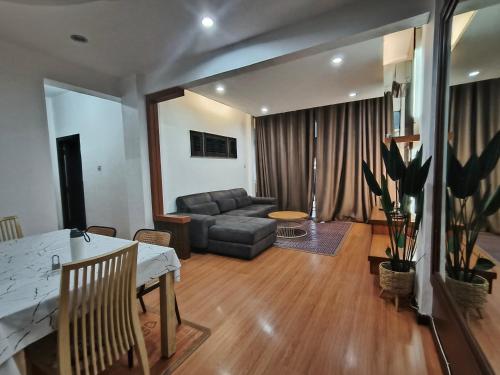 a living room with a couch and a table at Kuhara Homestay in Tawau
