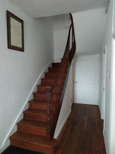 a staircase in a home with wooden floors at Chambre dans une maison bourgeoise 3 in Airvault