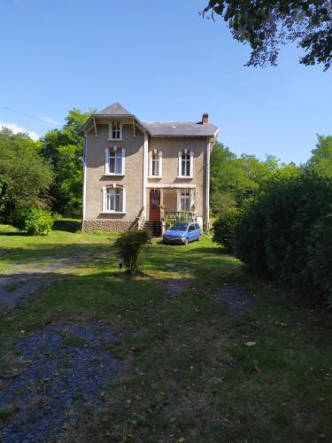 a house with a car parked in front of it at Chambre dans une maison bourgeoise 3 in Airvault