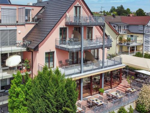 an aerial view of a pink building with balconies at Hotel Hagnauer Hof in Hagnau