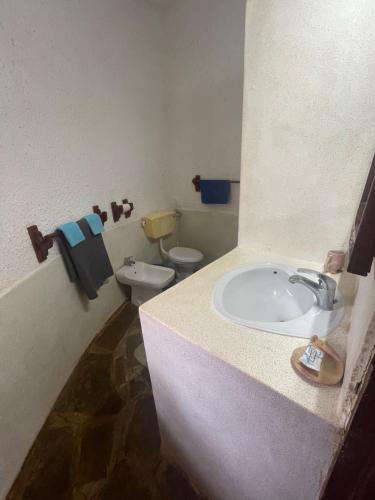 a bathroom with a sink and a toilet at Red Sunshine Villa B&B in Malindi