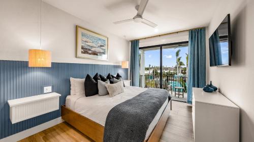 a bedroom with a bed and a balcony at Siesta Springs in Siesta Key