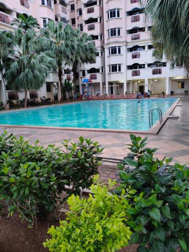 a large swimming pool in front of a building at Kuhara Homestay in Tawau