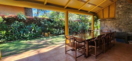 a dining table and chairs on a patio at Forest Cabin Unit 23A in Baguio