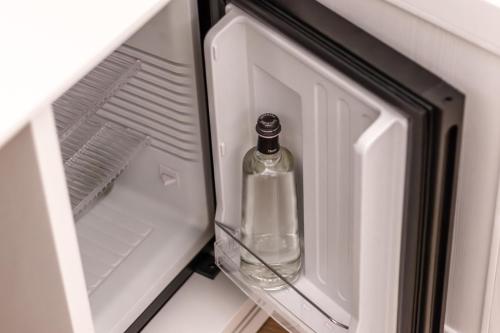 an empty bottle is sitting inside of an empty refrigerator at Relais Barchessa Molon in Campo di Pietra