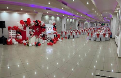 a large room with red and white decorations on the floor at Hotel Oaza in Kikinda