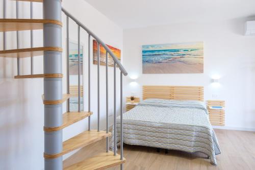 a bedroom with a bed next to a staircase at Eos affittacamere in Castelsardo
