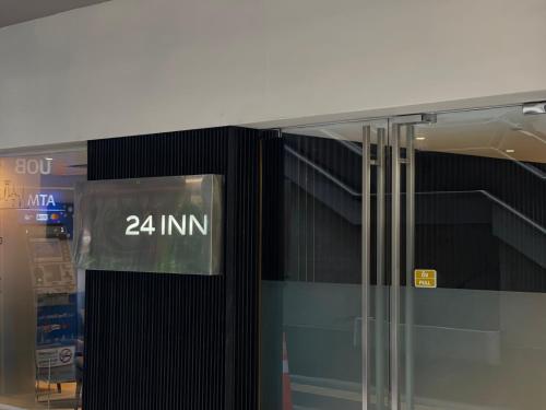 a glass door with the number on it at 24 Inn at BTS Phrom Phong in Bangkok